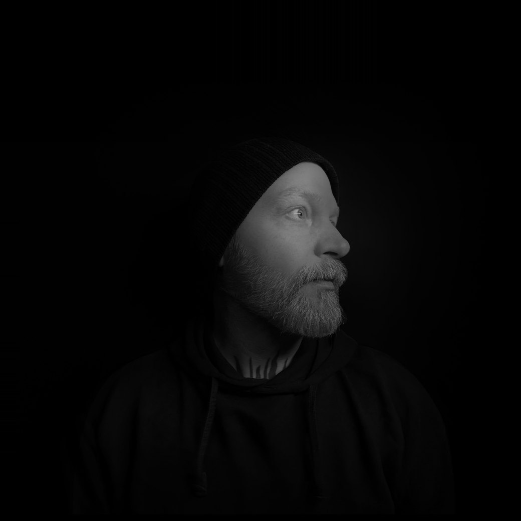 Black-and-white portrait of Jason Doherty in profile, wearing a beanie